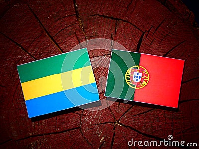 Gabon flag with Portuguese flag on a tree stump isolated Stock Photo