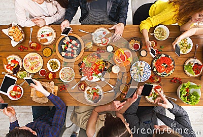 Gadget device addiction, friends dinner with smarphones Stock Photo