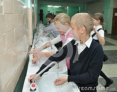 Students wash their hands before entering the dining room Editorial Stock Photo