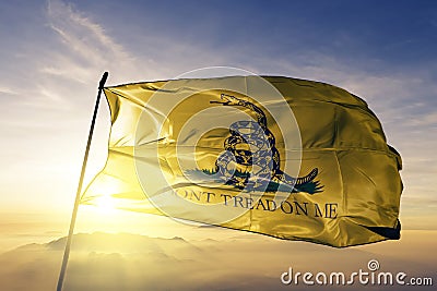 Gadsden flag textile cloth fabric waving on the top sunrise mist fog Stock Photo