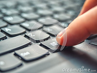 Galati, Romania - April 06, 2020: Laptop user pressing Windows Key on Microsoft Windows keyboard Editorial Stock Photo