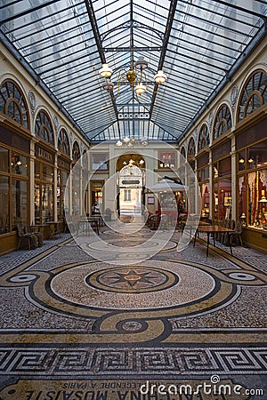 Galerie Vivienne, passage or shopping mall between Parisian apartment building in Paris Editorial Stock Photo
