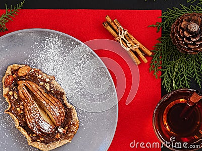 Galetta - homemade autumn pear cookies with cinnamon and creamy caramel in a ceramic plate on a red background. A cup of tea, Stock Photo