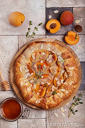 Galette with apricots, brown sugar, honey, and almond petals. Top view Stock Photo