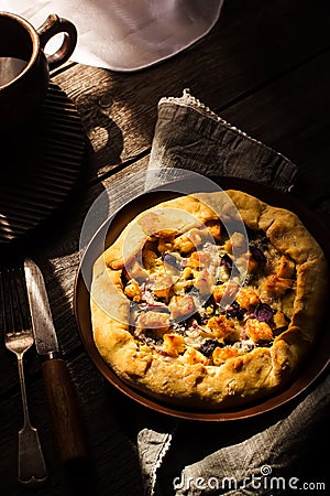 Galette with cheese on wooden table. Stock Photo