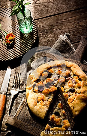 Galette with cheese on wooden table. Stock Photo