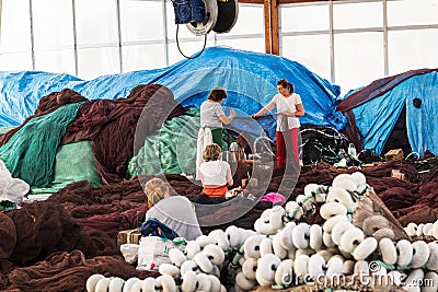 Galician net-menders repairing nets Editorial Stock Photo