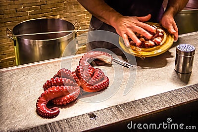 Melide, Spain - Galician Style Boiled Squid Octopus Being Prepared in one of the Traditional Restaurants in Melide, Spain Stock Photo
