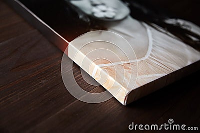 Gallery wrap, photography printed on synthetic canvas and stretched on wooden stretcher bar, lateral side closeup. Stock Photo