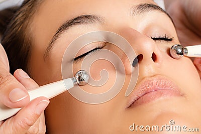 Galvanic facial treatment with low level current electrodes. Stock Photo