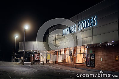 Galway city, Ireland - 21.12.2021: Dunnes stores Terryland building illuminated. Night scene. Dark and moody look Editorial Stock Photo