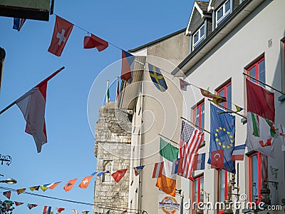 07/03/2019 Galway city, Ireland. International countries flags hanging over Shop street Editorial Stock Photo