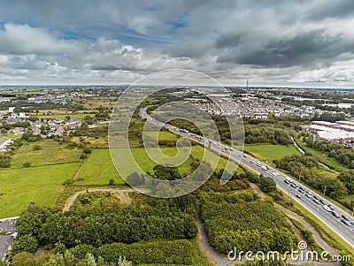 07/31/2019 Galway city, Ireland. Traffic jam on N6 road to town center. Aerial view. Cloudy day Editorial Stock Photo