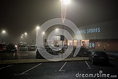 Galway, Ireland - 12.07.2020: Dunnes stores car park decorated for Christmas in a fog Editorial Stock Photo