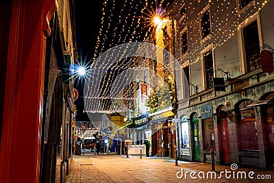 Galway, Ireland - 11/26/2020: Night scene, decorated and illuminated for Christmas Shop street Editorial Stock Photo