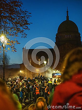 Galway, Ireland -29.10.2023: Scene at Macnas Halloween parade at Salmon Weir Bridge, Cathedral building in the background Editorial Stock Photo
