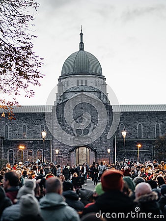 Galway, Ireland -29.10.2023: Scene at Macnas Halloween parade at Salmon Weir Bridge, Cathedral building in the background. Huge Editorial Stock Photo