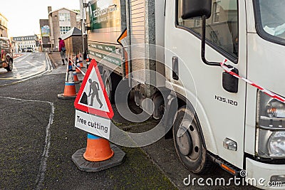 Galway, Ireland - 12.08.2020: Tree cutting service in town, Warning sign on the walk path Editorial Stock Photo