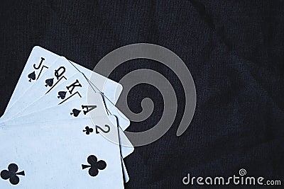 Gambling cards on a black cloth background. Stock Photo
