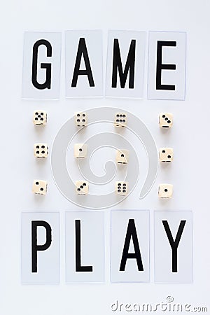 GAME PLAY words and gaming dice in row on white background. Stock Photo