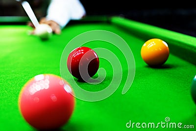 Game snooker billiards or opening frame player ready for the ball shot, athlete man kick cue on the green table in bar Stock Photo
