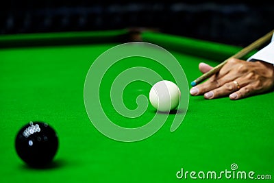 Game snooker billiards or opening frame player ready for the ball shot, athlete man kick cue on the green table in bar Stock Photo