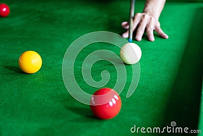 Game snooker billiards or opening frame player ready for the ball shot, athlete man kick cue on the green table in bar Stock Photo