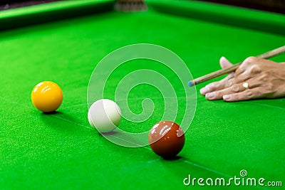 Game snooker billiards or opening frame player ready for the ball shot, athlete man kick cue on the green table in bar Stock Photo