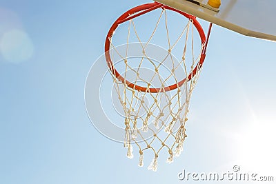 Game sports, competitions. Team sports, outdoor leisure, active recreation, entertainment. Basketball hoop with net against blue Stock Photo