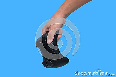 Gamepad in man hand on blue background, game joystick, computer games and entertainment Stock Photo