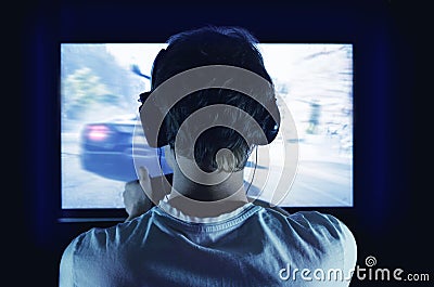 Gamer with gamepad happy to win in the online game, the player with headphones Stock Photo