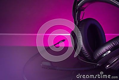 Gamer Headphones Dark Background and colorful Light. Stock Photo