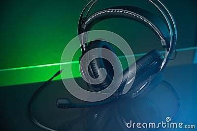 Gamer Headphones Dark Background and colorful Light. Stock Photo