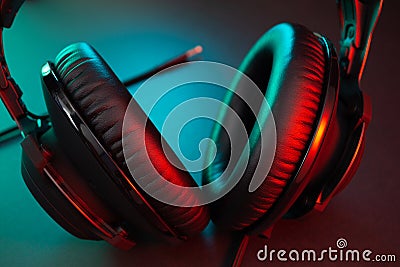 Gamer Headphones Dark Background and colorful Light. Stock Photo