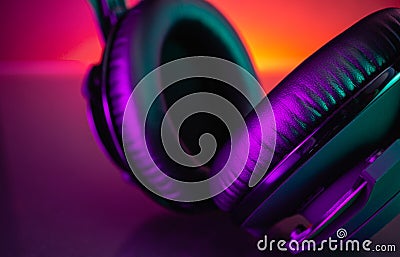 Gamer Headphones Dark Background and colorful Light. Stock Photo