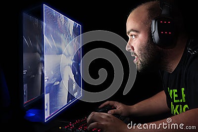 Gamer playing a first person shooter on high end pc. Stock Photo