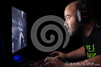 Gamer playing a first person shooter on high end pc. Stock Photo