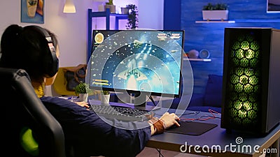 Gamer playing space shooter video game on powerful computer Stock Photo