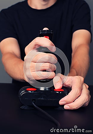 Gamer playing video game with retro joystick Stock Photo