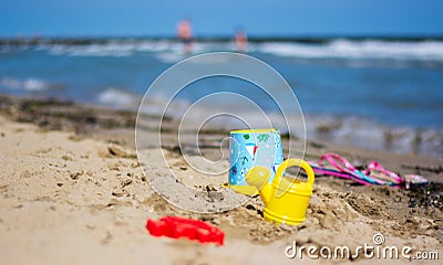 Games of forgotten children on the sand in front of the sea Stock Photo