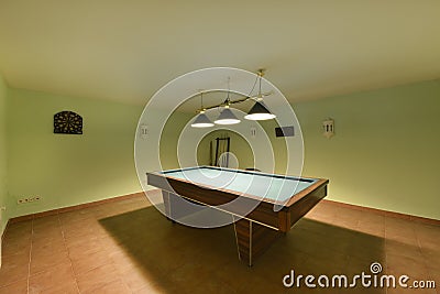 Games room on the ground floor of a detached house with a pool table and a dart board Stock Photo