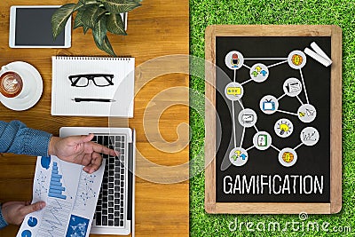 GAMIFICATION Businessman working at office desk and using computer and objects, Gamification Business Concept Stock Photo