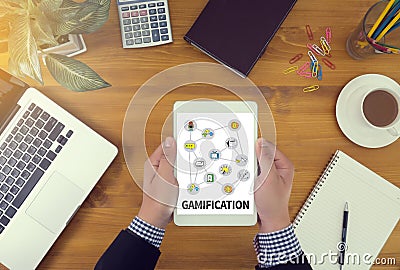 GAMIFICATION Businessman working at office desk and using computer and objects, Gamification Business Concept Stock Photo