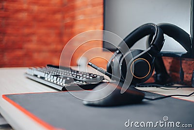 Gaming arena background with mouse gear headphones computer, focuse on headphones selected focuse Stock Photo