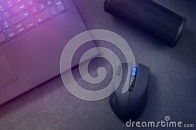 Gaming mouse and laptop at night. Stock Photo