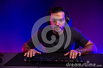 Gaming streamer concentrating gaming players trying to pass level. Surmise. Stock Photo