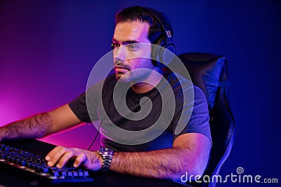 Gaming streamer concentrating gaming players trying to pass level. Surmise. Stock Photo