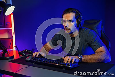 Gaming streamer concentrating gaming players trying to pass level. Surmise. Stock Photo