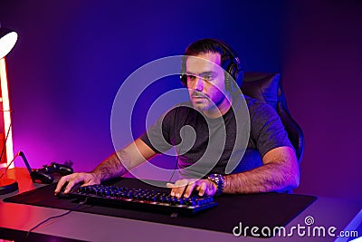 Gaming streamer concentrating gaming players trying to pass level. Surmise. Stock Photo