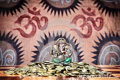 Ganesh on heap of coins Stock Photo